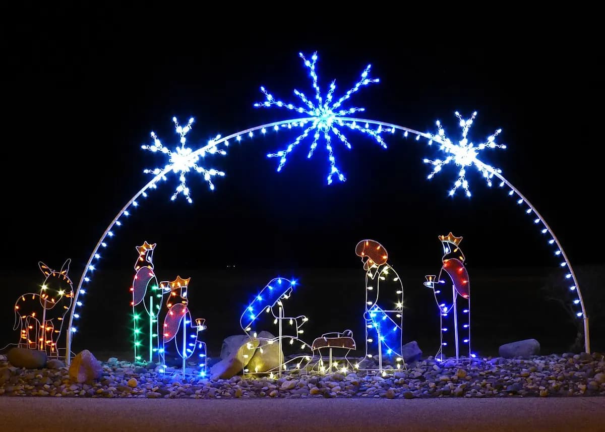 Depiction of the Nativity using Christmas lights. Removal of connective wires and piece of wood obscuring the creche using photo editing software.